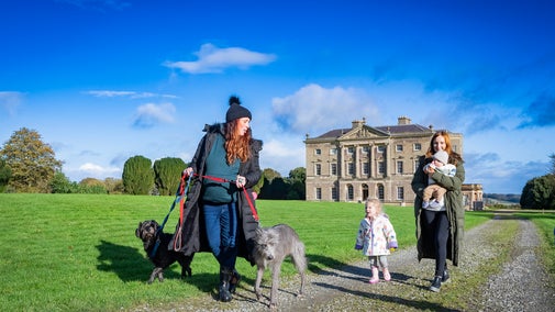 Family enjoying winter walk at the front of the mansion house